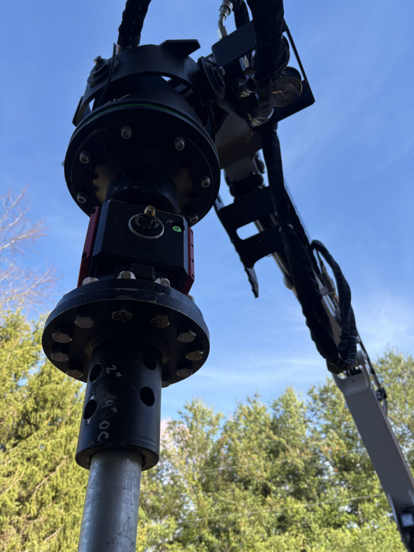 Close-up industrial robotic arm against blue sky