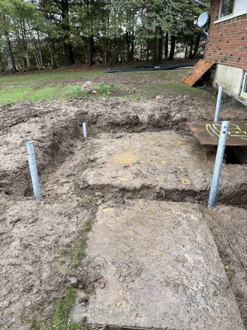 Backyard deck foundation with metal support posts