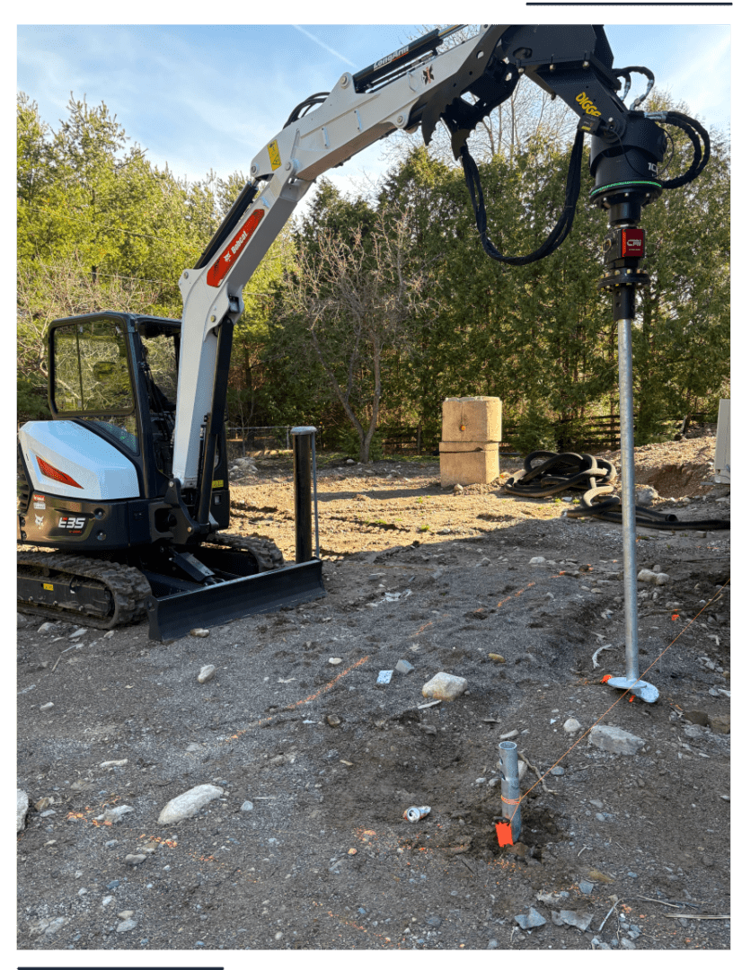 Mini excavator with auger drilling post hole